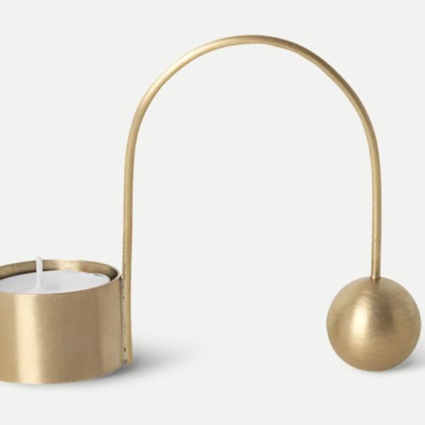 Gold candle holder with a sleek, curved arm and a modern design
