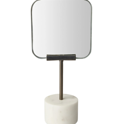 a white pedestal with a mirror on top of it