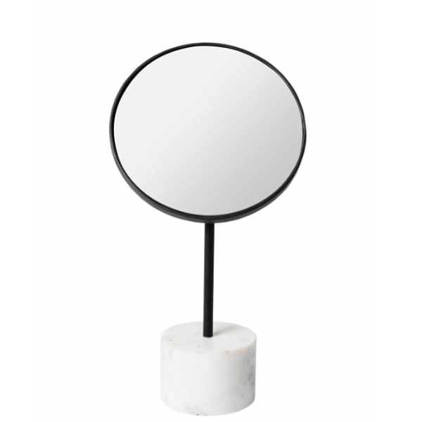 round table mirror with a black frame and marble base, positioned on a white surface
