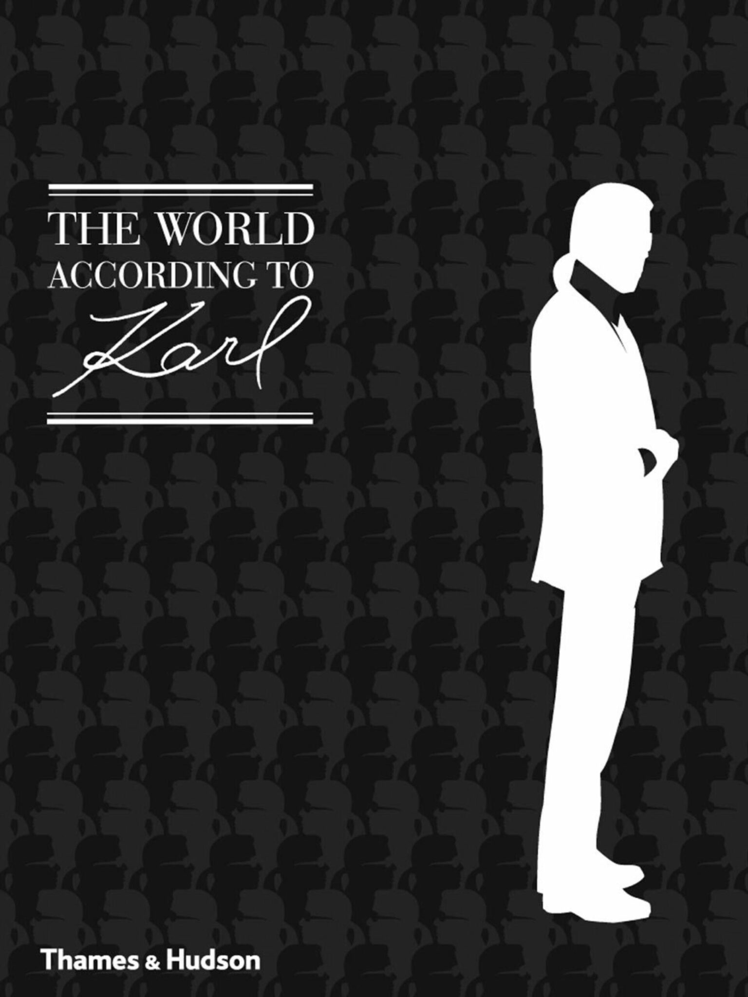 a man in a tuxedo standing in front of a black background