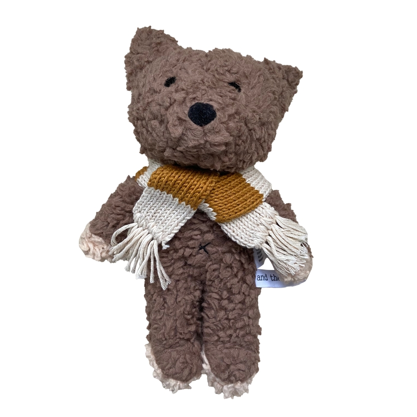 a brown teddy bear with a scarf around its neck
