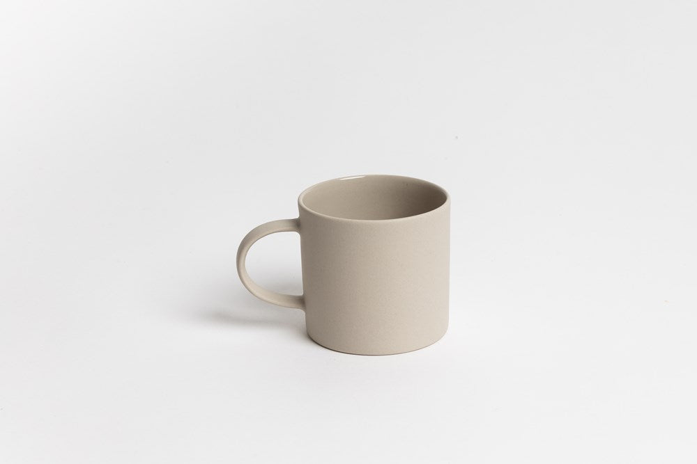72cc0f2c-e6ff-4d69-b54b-c0cf6a4da99a.jpg a white cup sitting on top of a white table