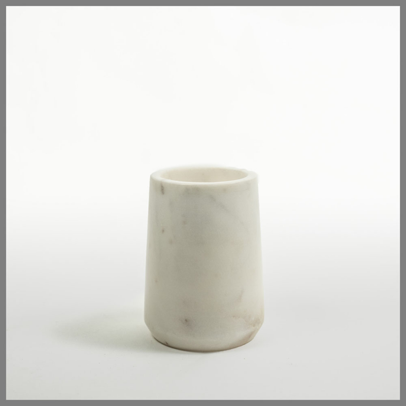 a white vase sitting on top of a white table