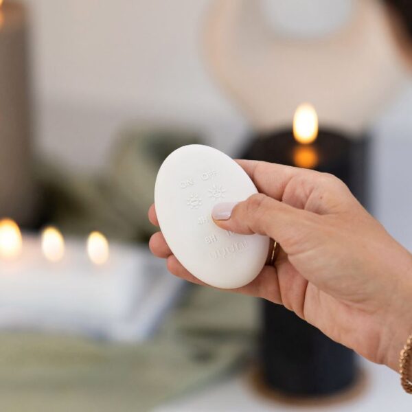 a person holding a white object in their hand