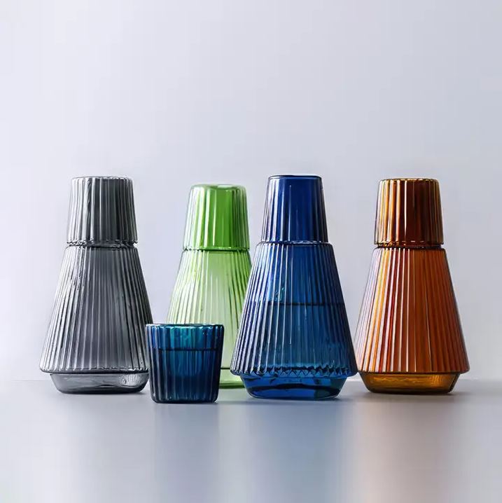a group of colorful vases sitting next to each other