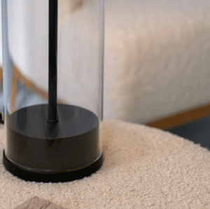 Ira Table Lamp in black with a modern silhouette and warm diffused light