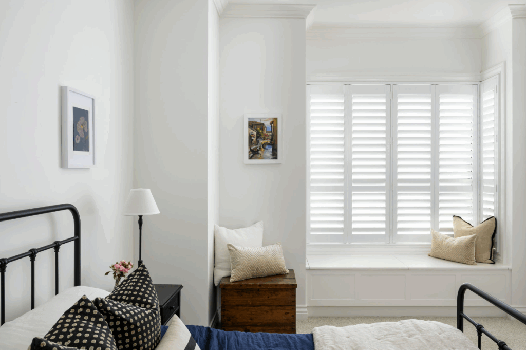 Custom white plantation shutters controlling light and heat in an Australian home