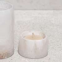 Small alabaster candle holder unlit showing natural stone veining and compact form